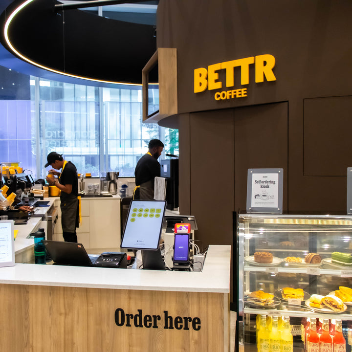 BETTR Coffee shop interior with counter and coffee-making equipment.